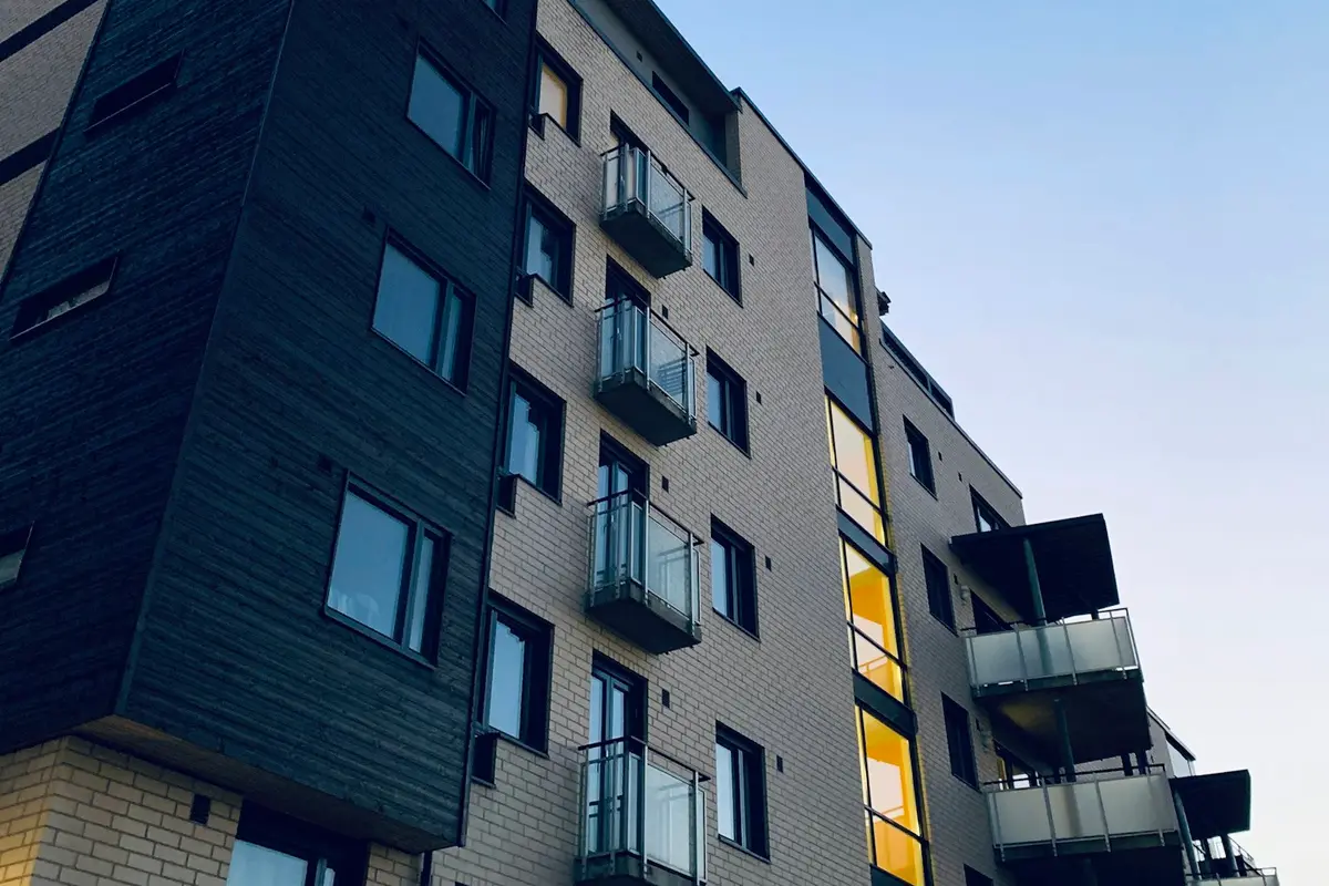 A modern apartment building with balconies against a blue sky