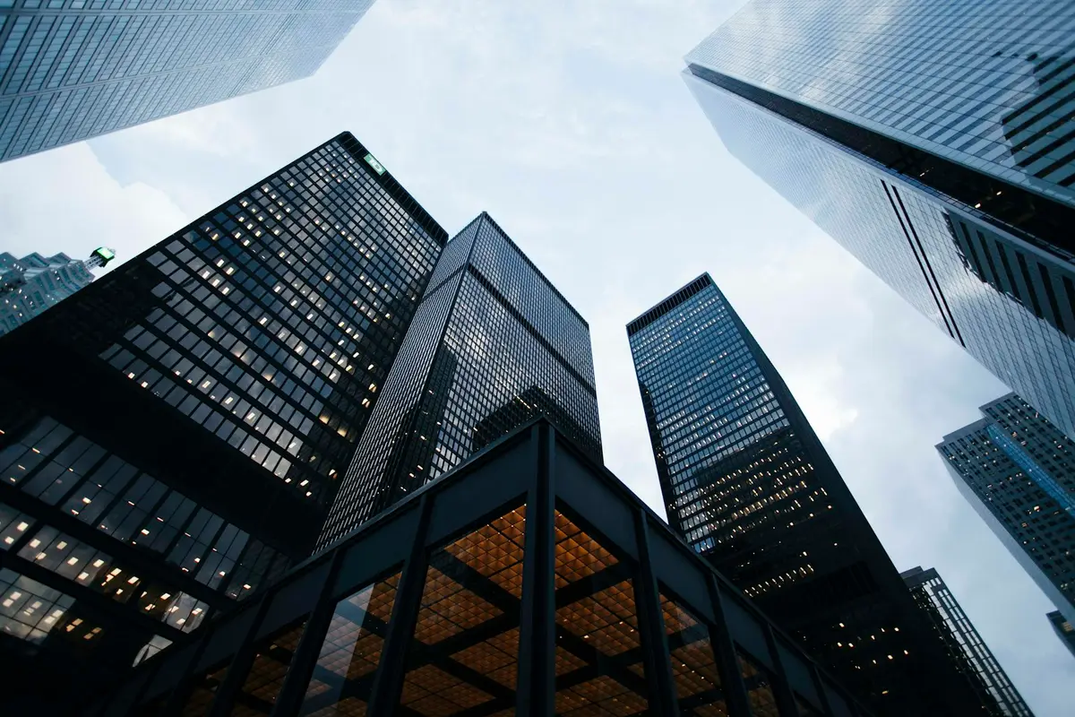 Tall glass office buildings seen from below