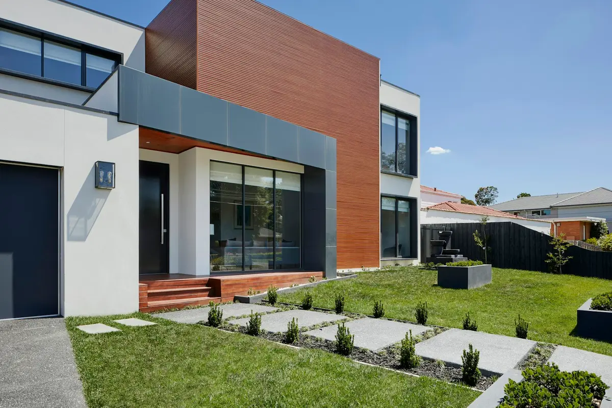 The front of a modern house with a lawn and path